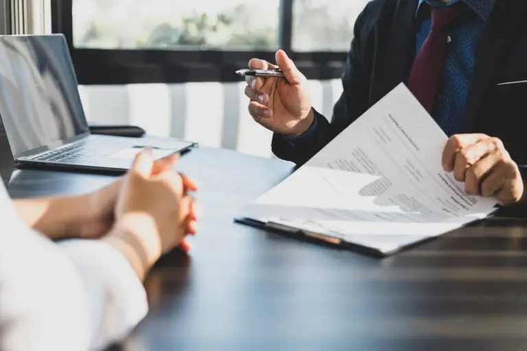 Professionals reviewing a client contract at a table